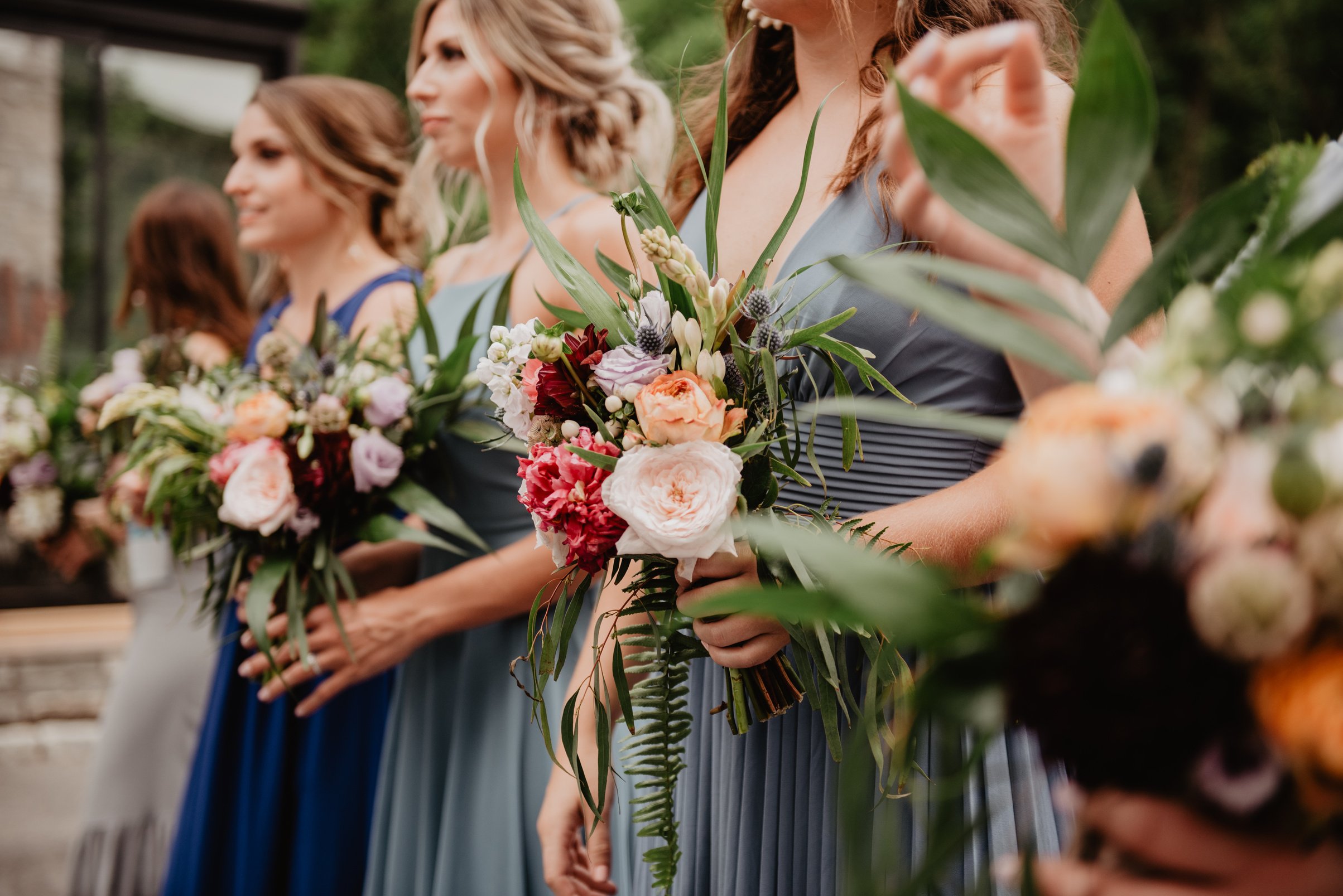 Selective Focus Photography of Women Holding Wedding Flowers